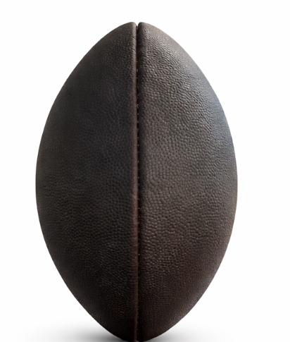 Dark, seasoned leather football after a full team prep — mudded, brushed, and conditioned