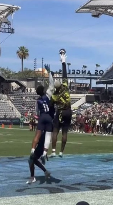 Player going up for a football at a 7v7 tournament — game-ready prepped football